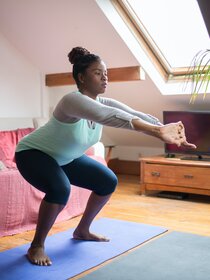 Woman doing exercises in her living room