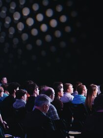 Image of people sitting at a conference