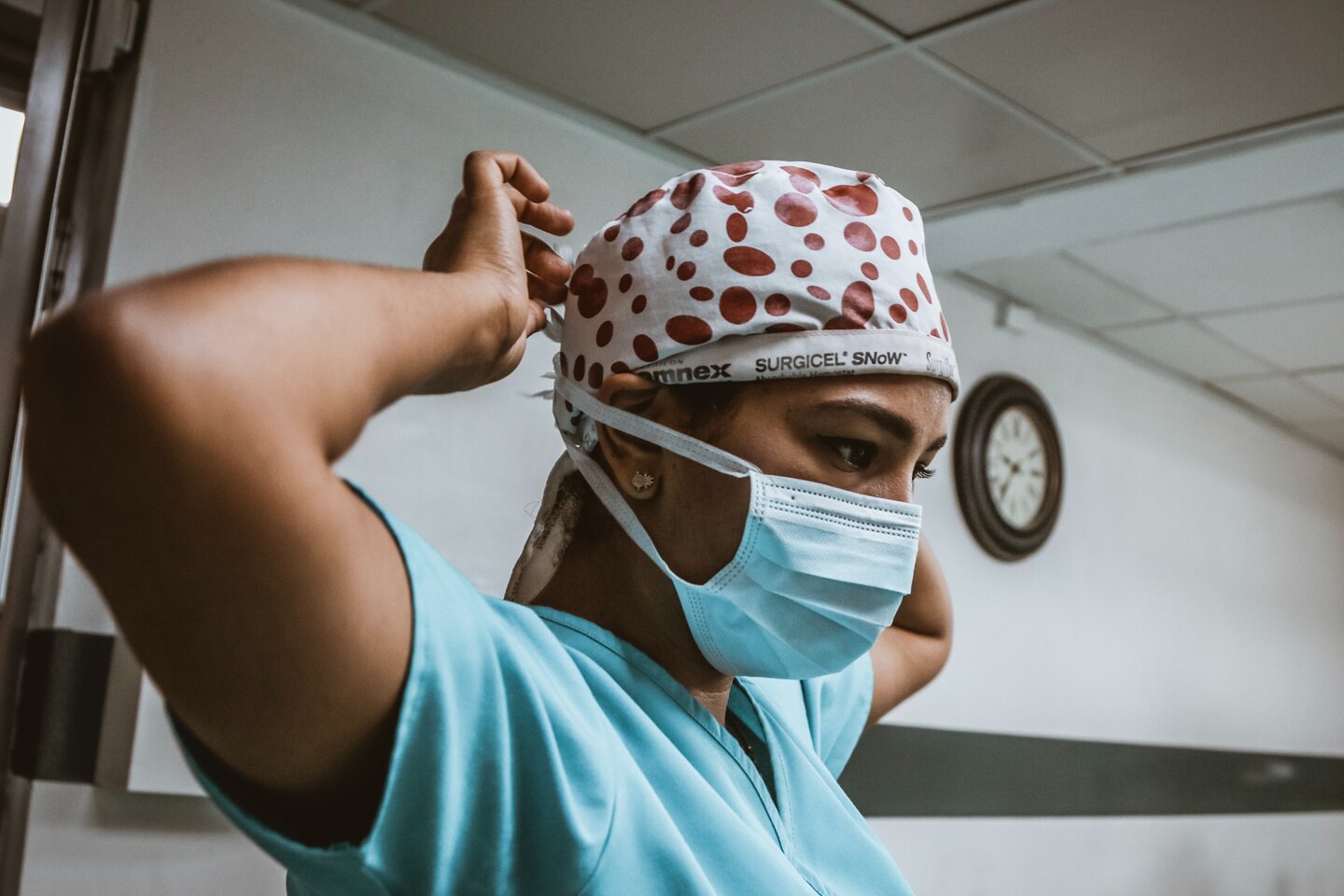 Woman in medical field tightening mask