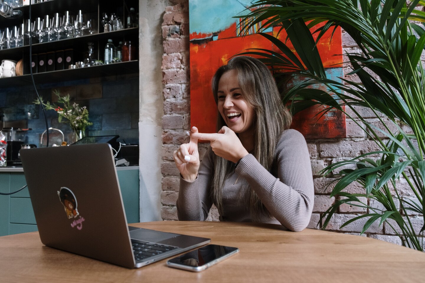 Image of woman signing to laptop