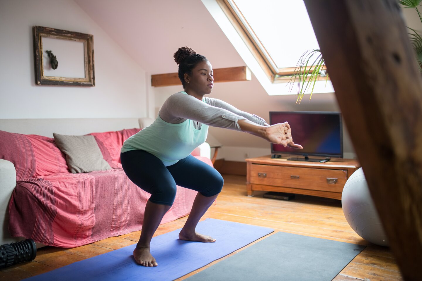 Woman doing exercises in her living room
